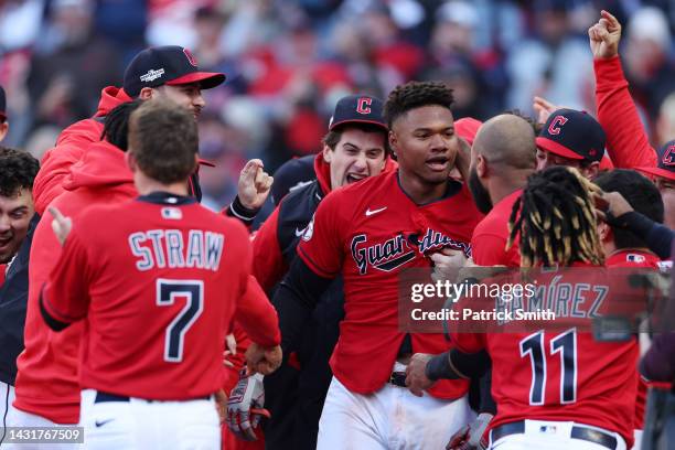 Oscar Gonzalez of the Cleveland Guardians celebrates with teammates after hitting a walk-off home run to end the game in the fifteenth inning against...