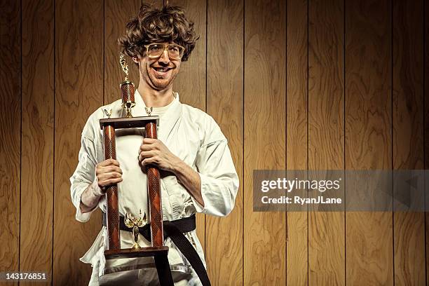 karate nerd is proud of his trophy - high contrast athlete stock pictures, royalty-free photos & images