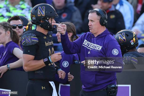 Head coach Pat Fitzgerald of the Northwestern Wildcats talks with Brendan Sullivan against the Wisconsin Badgers during the first half at Ryan Field...