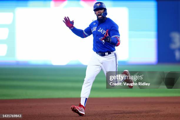 Teoscar Hernandez of the Toronto Blue Jays celebrates after hitting a home run to center field against Robbie Ray of the Seattle Mariners during the...