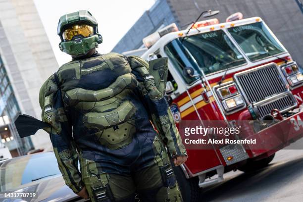 Person in a "Halo" costume poses near an FDNY firetruck outside New York Comic Con 2022 on October 08, 2022 in New York City. The four-day event,...
