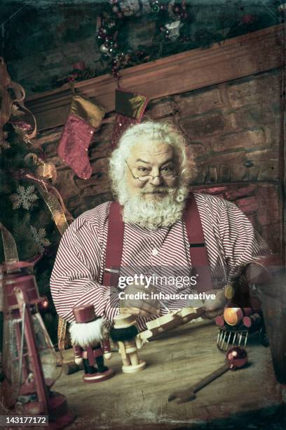 pictures of real vintage santa claus in his workshop - santas workshop stock pictures, royalty-free photos & images
