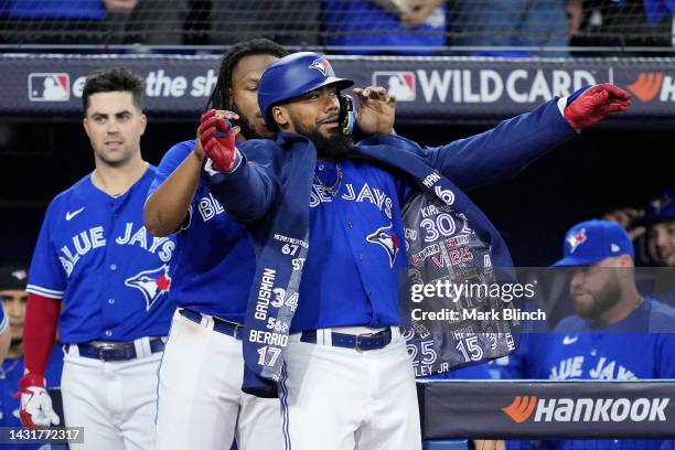 Teoscar Hernandez of the Toronto Blue Jays celebrates with Vladimir Guerrero Jr. #27 after hitting a home run to center field against Robbie Ray of...