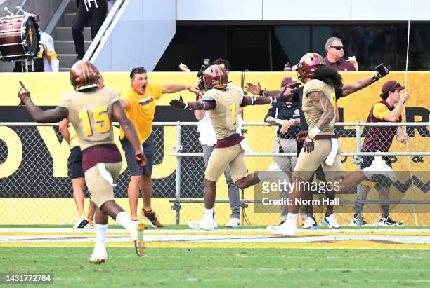 Jordan Clark of the Arizona State University Sun Devils celebrates with teammates and fans after scoring a touchdown on an interception against the...