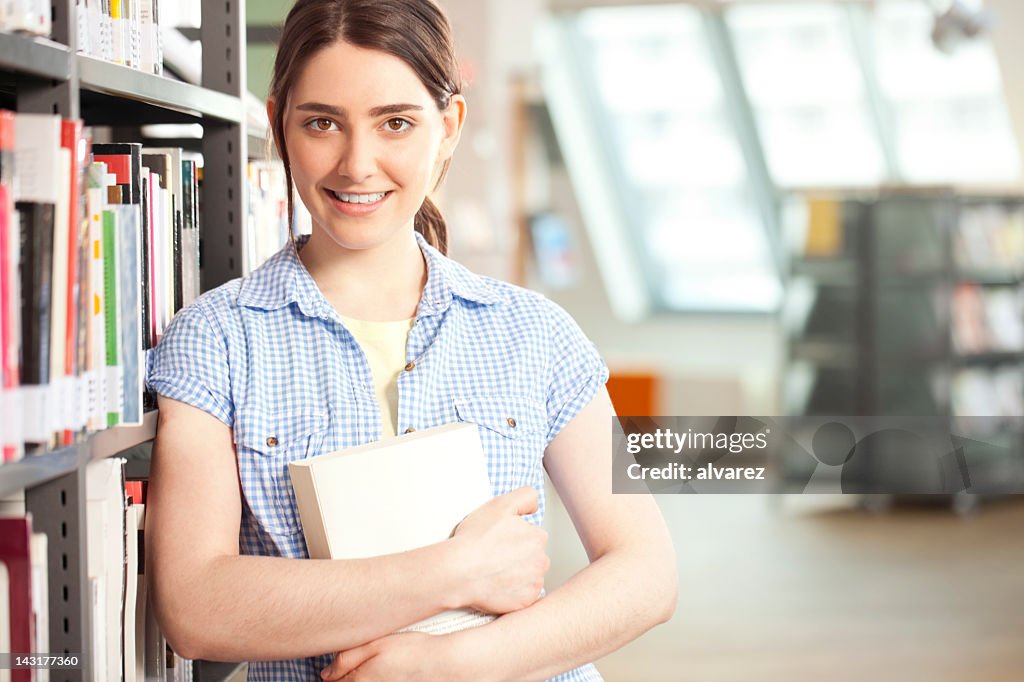 Young woman studying at the library