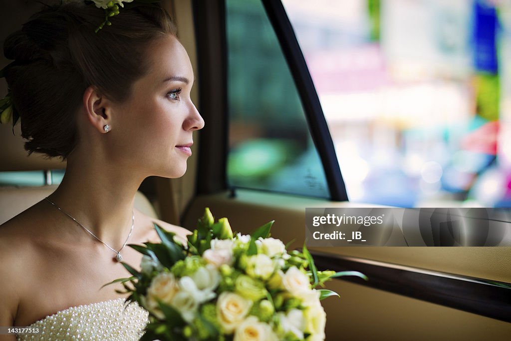Young bride sitting in the car