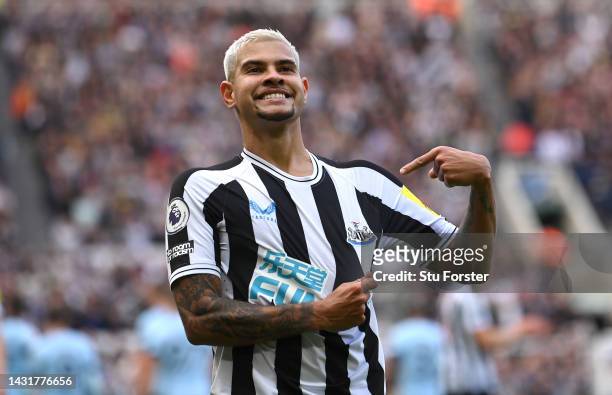 Newcastle player Bruno Guimaraes celebrates his second goal by pointing to the club badge during the Premier League match between Newcastle United...