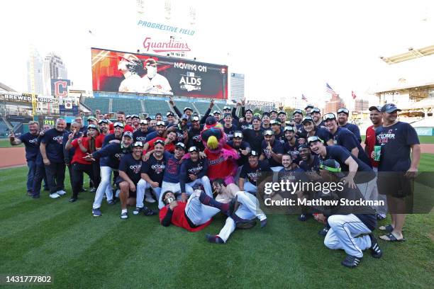 Members of the Cleveland Guardians pose for photos on the field after defeating the Tampa Bay Rays in game two of the Wild Card Series at Progressive...