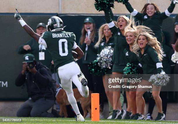 Charles Brantley of the Michigan State Spartans celebrates a first half interception for a touchdown while playing the Ohio State Buckeyes at Spartan...
