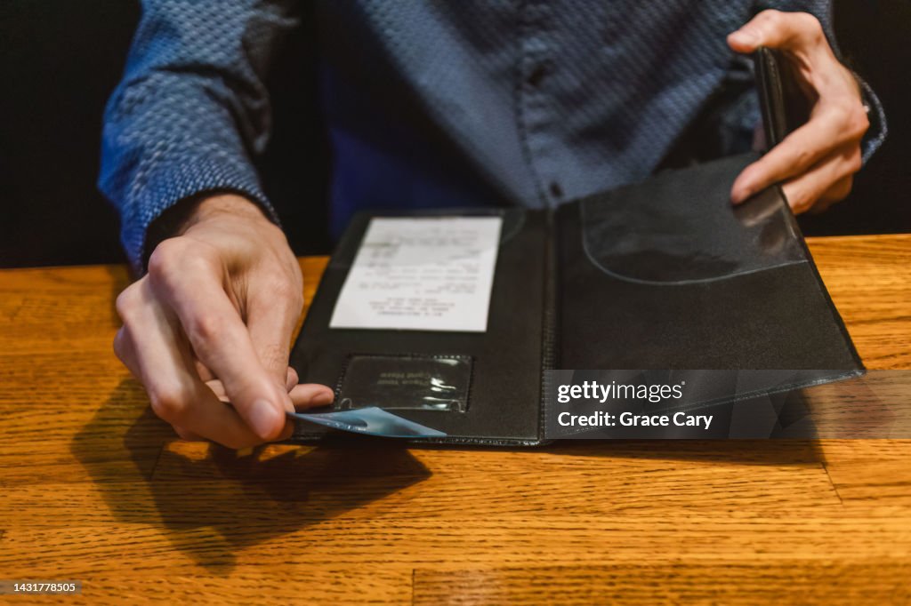 Man Pays Restaurant Bill with Credit Card
