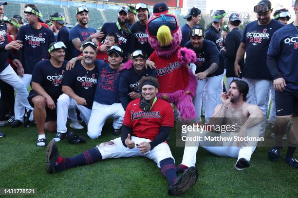 Members of the Cleveland Guardians pose for photos on the field after defeating the Tampa Bay Rays in game two of the Wild Card Series at Progressive...
