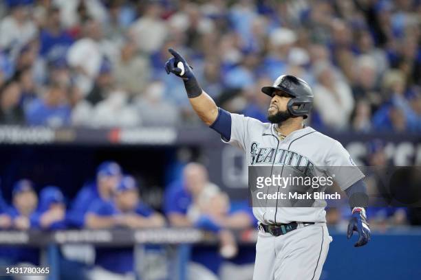 Carlos Santana of the Seattle Mariners celebrates after hitting a three run home run against the Toronto Blue Jays during the sixth inning in game...