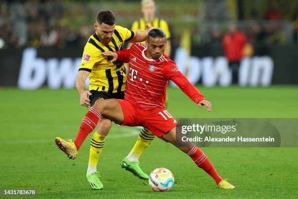 Salih Özcan of Dortmund battles for the ball with Leroy Sane of Bayern München during the Bundesliga match between Borussia Dortmund and FC Bayern...