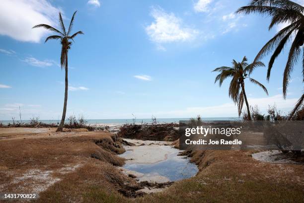 The ground is sunken in after the surge waters carved it out when Hurricane Ian passed through the area on October 08, 2022 in Sanibel, Florida....