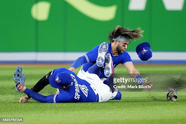 George Springer of the Toronto Blue Jays collides with Bo Bichette in the outfield against the Seattle Mariners during the eighth inning in game two...