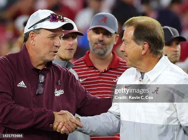 Head coach Jimbo Fisher of the Texas A&M Aggies and head coach Nick Saban of the Alabama Crimson Tide shake hands during pregame warmups at...