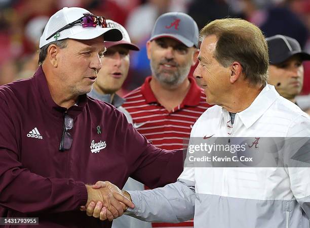 Head coach Jimbo Fisher of the Texas A&M Aggies and head coach Nick Saban of the Alabama Crimson Tide shake hands during pregame warmups at...