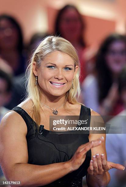 Wrestler Elizabeth Carolan Kocanski, aka Beth Phoenix, applauds as she takes part in the TV show "Le grand journal" on a set of French TV Canal+, on...
