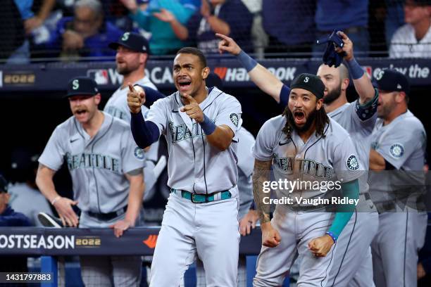 Julio Rodriguez and J.P. Crawford of the Seattle Mariners celebrate Adam Frazier RBI double to take the lead against the Toronto Blue Jays during the...