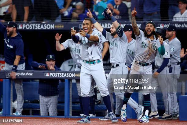 Julio Rodriguez and J.P. Crawford of the Seattle Mariners celebrate Adam Frazier RBI double to take the lead against the Toronto Blue Jays during the...
