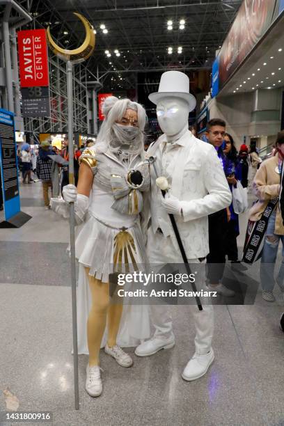 Cosplayers dressed as "Sailor Moon Knight" and Moon Knight pose during New York Comic Con 2022 on October 08, 2022 in New York City.