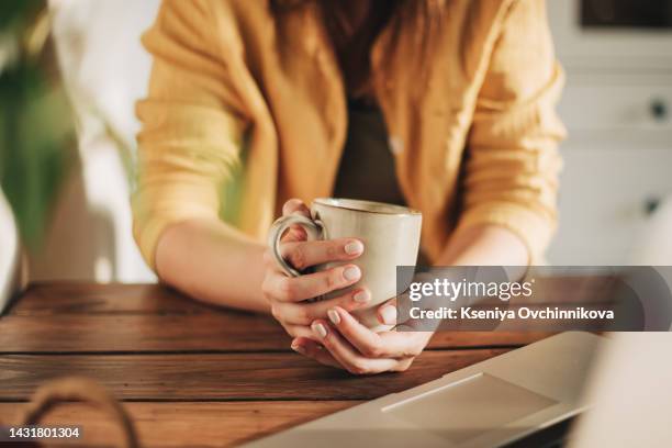 morning, breakfast coffee and female hands pouring water in cup from retro kettle in kitchen at home. woman in pajamas brewing tea or making a beverage on counter to start the day. - cup of coffee fotografías e imágenes de stock