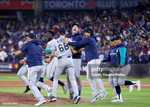 George Kirby of the Seattle Mariners celebrates with his teammates after defeating the Toronto Blue Jays in game two to win the American League Wild...