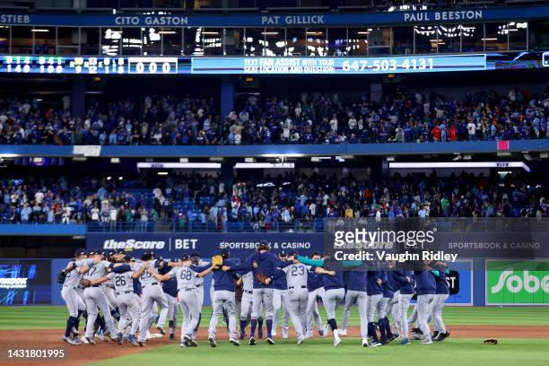 The Seattle Mariners celebrate after defeating the Toronto Blue Jays in game two to win the American League Wild Card Series at Rogers Centre on...
