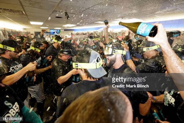The Seattle Mariners celebrate in the locker room after defeating the Toronto Blue Jays in game two to win the American League Wild Card Series at...