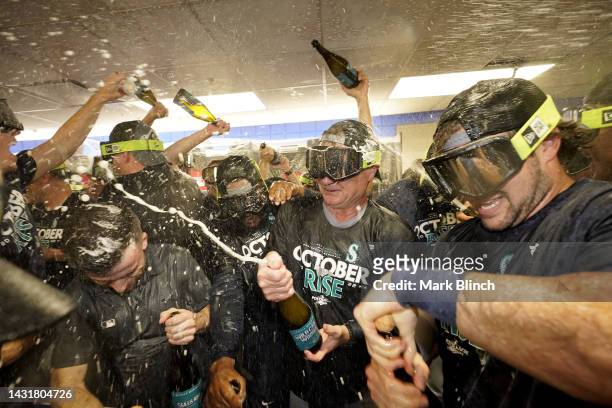 Scott Servais of the Seattle Mariners celebrates with the team in the locker room after defeating the Toronto Blue Jays in game two to win the...
