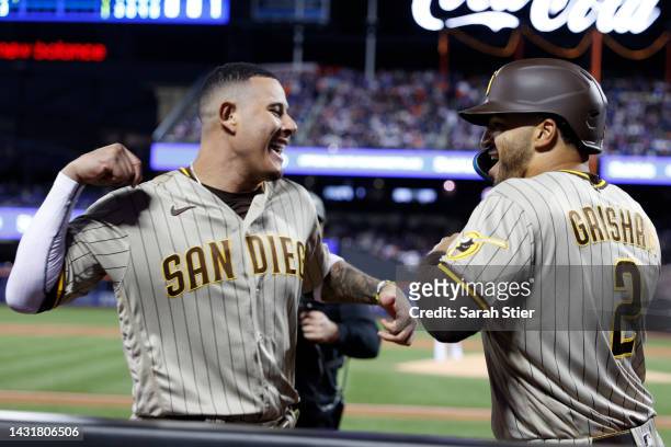 Trent Grisham of the San Diego Padres celebrates his solo home run with Manny Machado during the third inning off of Jacob deGrom of the New York...