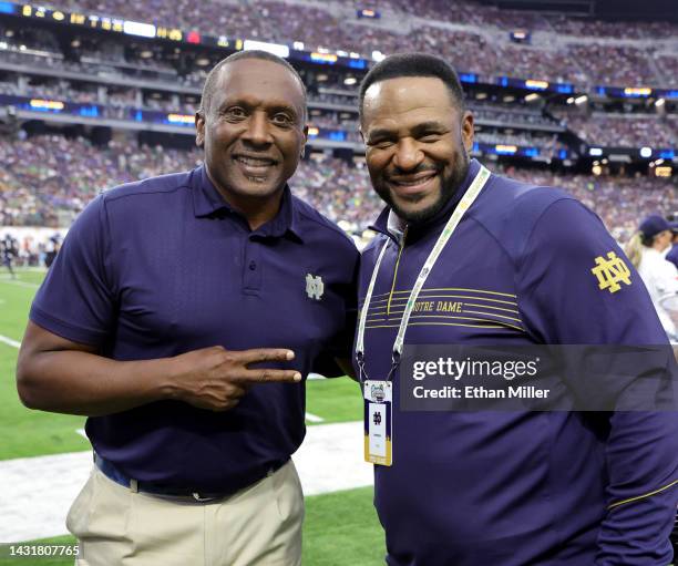 Notre Dame alumni and Pro Football Hall of Fame members Tim Brown and Jerome Bettis pose on the Notre Dame sideline during the Shamrock Series game...