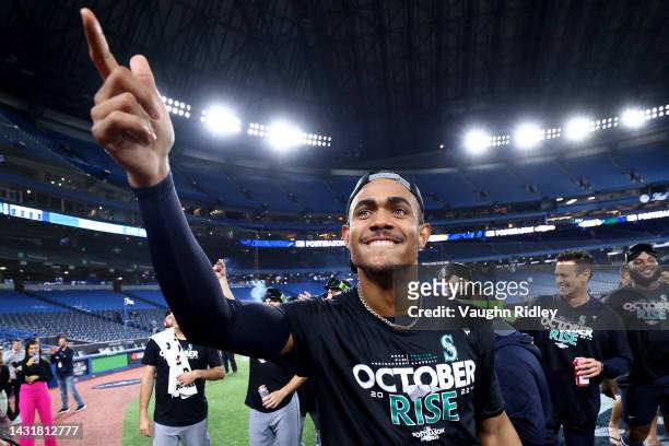 Julio Rodriguez of the Seattle Mariners celebrates on the field after defeating the Toronto Blue Jays in game two to win the American League Wild...