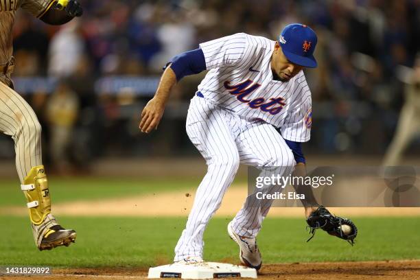 Edwin Diaz of the New York Mets makes a tag at first base on a hit from Jurickson Profar of the San Diego Padres during the seventh inning in game...