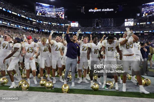 Head coach Marcus Freeman of the Notre Dame Fighting Irish celebrates with his players after the team's 28-20 victory over the Brigham Young Cougars...
