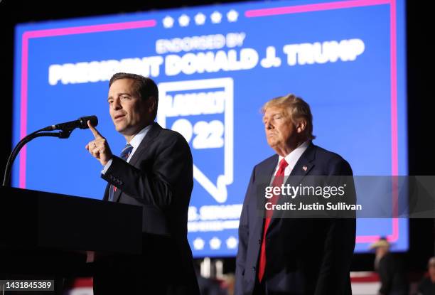 Nevada republican U.S. Senate candidate Adam Laxalt joins former U.S. President Donald Trump on stage during a campaign rally at Minden-Tahoe Airport...