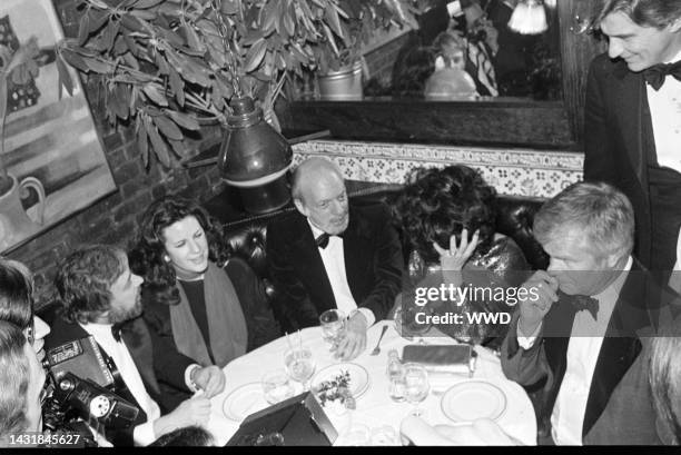 Stephen Sondheim , Harold Prince , Elizabeth Taylor , and John Warner attend a party at the Ginger Man restaurant in New York City on March 6, 1978.