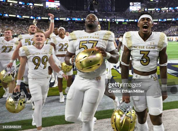 Place kicker Blake Grupe, defensive lineman Jayson Ademilola and safety Houston Griffith of the Notre Dame Fighting Irish celebrate after the team's...