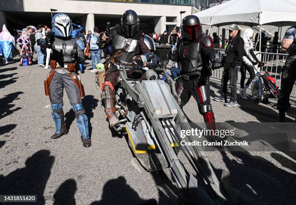 Cosplayers pose as characters from "The Mandalorian" during day 3 of New York Comic Con on October 08, 2022 in New York City.