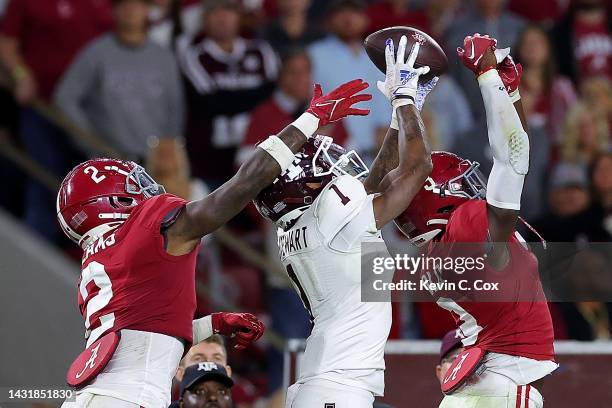 Evan Stewart of the Texas A&M Aggies pulls in this reception against Terrion Arnold and DeMarcco Hellams of the Alabama Crimson Tide during the...