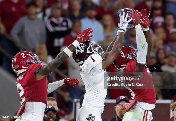 Evan Stewart of the Texas A&M Aggies pulls in this reception against Terrion Arnold and DeMarcco Hellams of the Alabama Crimson Tide during the...