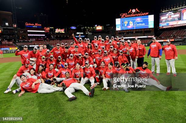 The Philadelphia Phillies pose on the field after defeating the St. Louis Cardinals in game two to win the National League Wild Card Series at Busch...