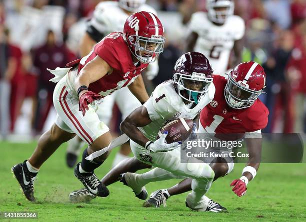 Evan Stewart of the Texas A&M Aggies pulls in this reception against Kool-Aid McKinstry and Henry To'oTo'o of the Alabama Crimson Tide during the...