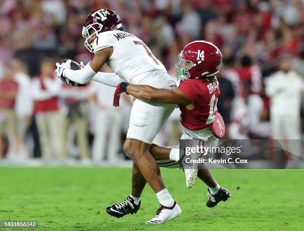 Moose Muhammad III of the Texas A&M Aggies pulls in this reception against Brian Branch of the Alabama Crimson Tide during the first half at...