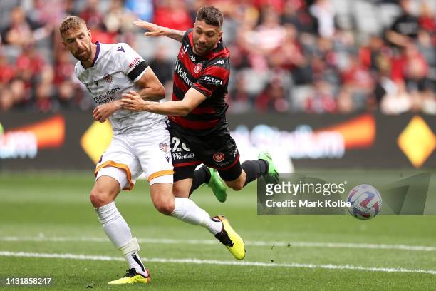 Mark Beevers of the Glory tackles Brandon Borrello of the Wanderers during the round one A-League Men's match between Western Sydney Wanderers and...