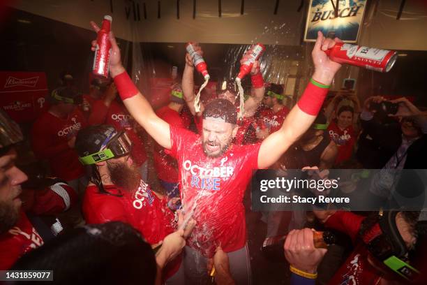 Kyle Schwarber of the Philadelphia Phillies celebrates with his teammates in the locker room after defeating the St. Louis Cardinals in game two to...