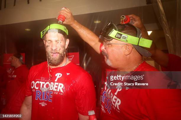 Bryce Harper of the Philadelphia Phillies celebrates with his teammates in the locker room after defeating the St. Louis Cardinals in game two to win...