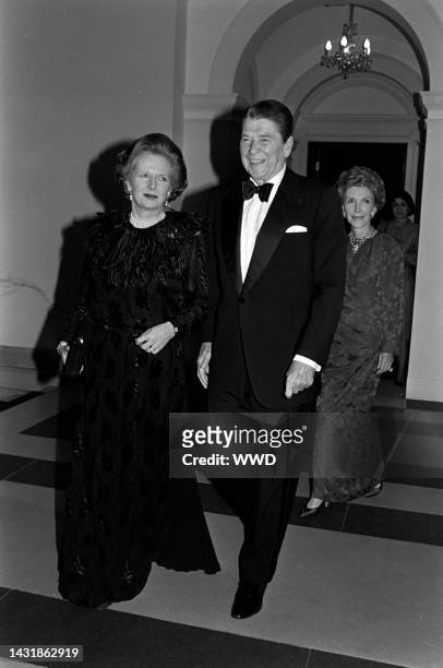 Margaret Thatcher, Ronald Reagan, and Nancy Reagan attend a party at the British embassy in Washington, D.C., on February 20, 1985.