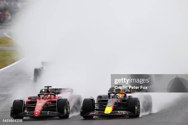 Max Verstappen of the Netherlands driving the Oracle Red Bull Racing RB18 and Charles Leclerc of Monaco driving the Ferrari F1-75 battle for track...