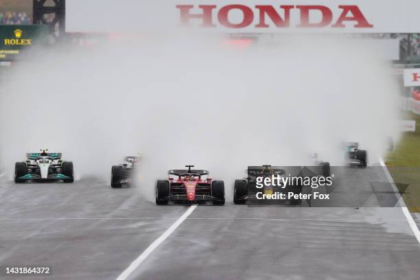 Max Verstappen of the Netherlands driving the Oracle Red Bull Racing RB18 and Charles Leclerc of Monaco driving the Ferrari F1-75 battle for track...